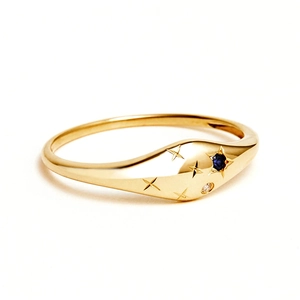 Detailed view of gold S925 sterling silver ring with blue sapphire and star engravings