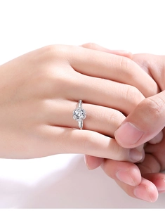 Close-up of a 1-carat moissanite ring with a classic round cut and four-prong silver setting