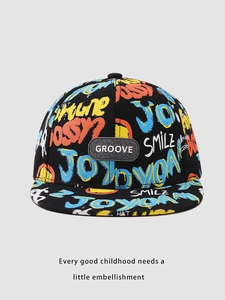 Close-up of a colorful graffiti kids' flat brim hip-hop hat with a rubber GROOVE patch