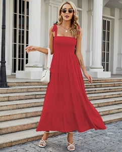 Detailed view of red maxi dress featuring bow shoulder straps and smocked bodice details