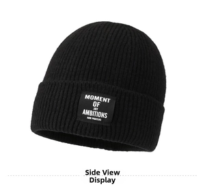 Close-up of black ribbed knit beanie featuring an embroidered square logo patch on the cuff
