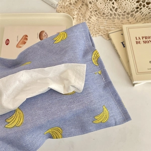 Close-up of fabric car tissue box featuring yellow banana prints on a blue cotton background