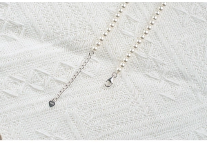 Close-up of S925 sterling silver clasp and extension chain on a round pearl necklace