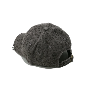Detail view of dark grey leopard print baseball cap with metallic rings and adjustable buckle