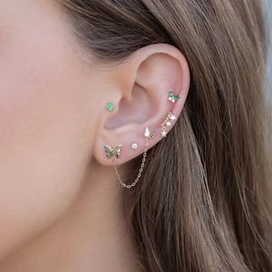 Close-up of gold S925 silver ear wire earrings with opal tassels and butterfly studs