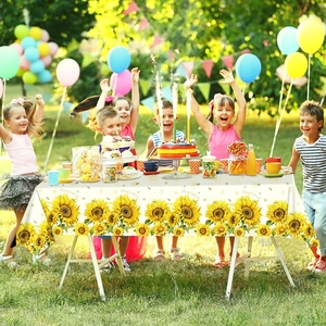 Floral sunflower party tablecloth for children's birthday events in outdoor setting