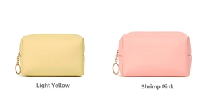Detail of waterproof PU leather cosmetic bags in yellow and pink with gold ring zippers
