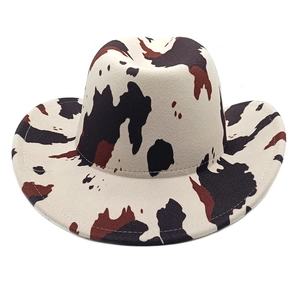 Detailed cow print texture and stitching on a felt western cowboy sun hat with wide brim