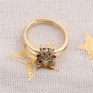 Macro shot of gold-plated bear ring with colorful cubic zirconia stones and open design