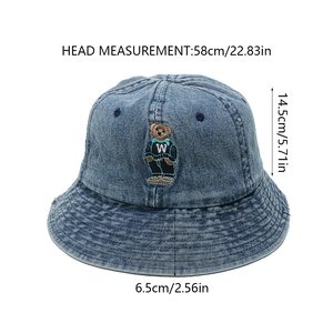 Detail view of washed denim bucket hat with bear embroidery and size measurements