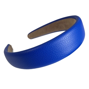 Klein blue sponge headband with elegant lychee pattern leather texture on white backdrop