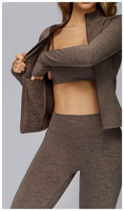 Detail of thumbhole cuff and moisture-wicking fabric on brown marled yoga jacket