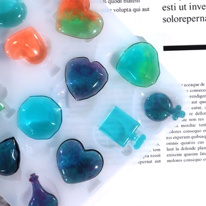 Vista macro dello stampo in silicone con forme a cuore e flacone di profumo sfumato