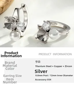 Macro detail of silver 316L stainless steel earring with pearl and cubic zirconia stone