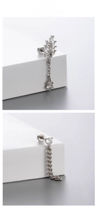 Detail of silver titanium steel earrings with heart and leaf crystal drop fringe chains