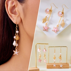 Long ocean-themed tassel earrings with starfish shell charms and pearls on a gold hook