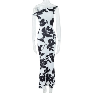 Detail of slim fit bodycon dress with black and white floral print and one-shoulder cut