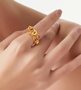 Macro detail of French vintage multi-layer gold plated titanium steel beaded ring on finger