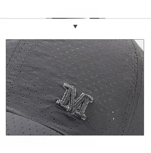 Detailed close-up of dark grey quick-dry mesh cap with high-quality M letter embroidery