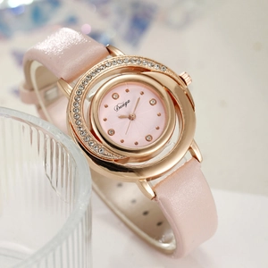 Close-up of pink leather watch with gold rhinestone bezel and elegant brand logo