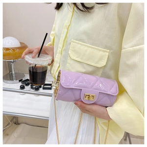 Close-up of a purple quilted cylinder jelly bag with gold chain strap and metal lock