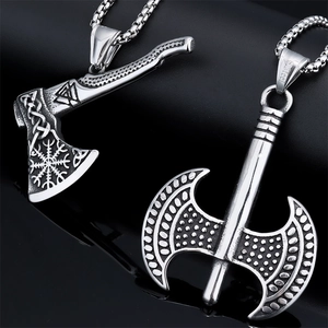 Macro view of double-sided Viking axe pendants in stainless steel with Nordic engraving