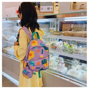 Close-up of purple floral kids backpack with matching small coin purse pendant
