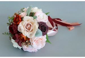 Close-up of artificial bridal bouquet with silk roses, peonies and elegant ribbons
