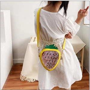 Girl wearing a cute strawberry-shaped jelly bag with pink sequins and yellow PU strap