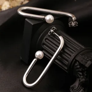 Minimalist silver U-shaped pearl earrings with elegant drop design for women