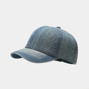 Detail view of washed blue denim baseball cap with vintage six-panel stitching and top button