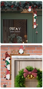 Close-up of wooden Christmas gnome door frame decor with XMAS lettering and Holy Jolly tags