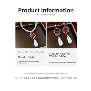 Detail showing vintage water drop pearl necklace and earrings with red gemstone inlay