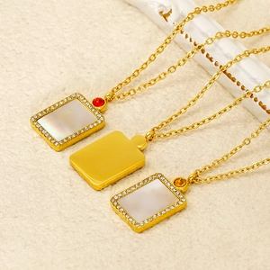 Close-up of rectangle shell pendants with zircon borders on gold stainless steel necklaces