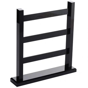 Detailed view of 3-tier black acrylic earring display stand with multiple hanging holes