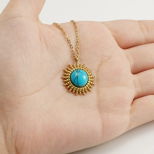 18K gold plated stainless steel necklace with sunburst turquoise pendant in hand