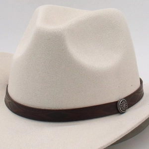 Close-up of beige felt fedora hat featuring a dark brown leather band and embossed metal buckle