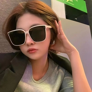 Stylish beige square oversized sunglasses for women with dark lenses and metal rivet details