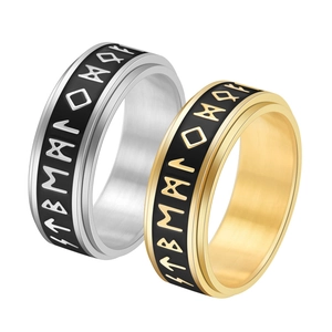 Detail of rotating Viking rune rings in gold and silver finish with brushed metal texture