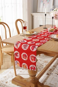 Detail of red festive table runner with traditional Chinese New Year patterns and motifs