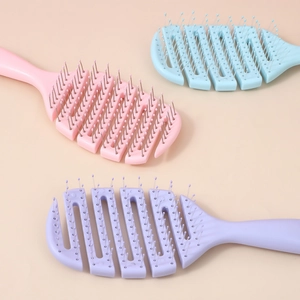 Set of three vent hair brushes in pink, blue, and purple for voluminous hair styling