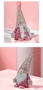 Detail showing a pink Christmas gnome plush with sequined hat and plush texture