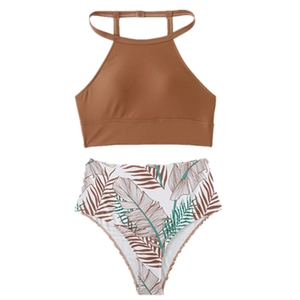 Women's two-piece bikini with caramel halter top and tropical palm leaf high-waist bottom