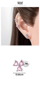 Macro detail of a clover-shaped cartilage stud with pink heart zircon and screw-back post