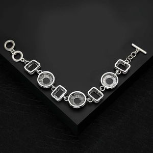 Close-up of vintage silver bracelet with geometric hollow rings and toggle clasp