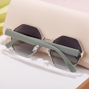 Detail of polygon metal sunglasses with sage green temples and black gradient lenses