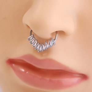 Detail shot of a silver septum ring with rectangular crystals on a model nose