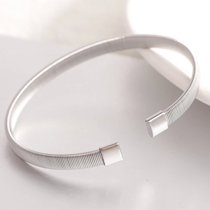 Detail shot of a silver 6mm stainless steel elastic wire cuff with square polished ends