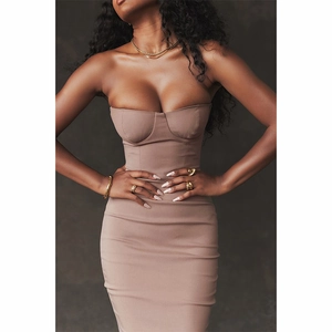 Close-up detail of a brown strapless knit dress with elegant gold jewelry accessories
