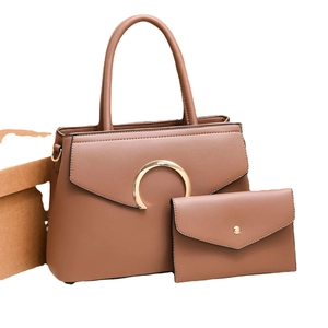 Brown two-piece fashion handbag set with gold buckle and matching envelope pouch